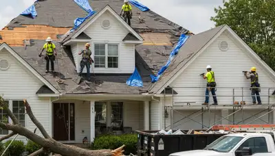 Storm damage cleanup crew removing fallen tree debris in Albany, NY